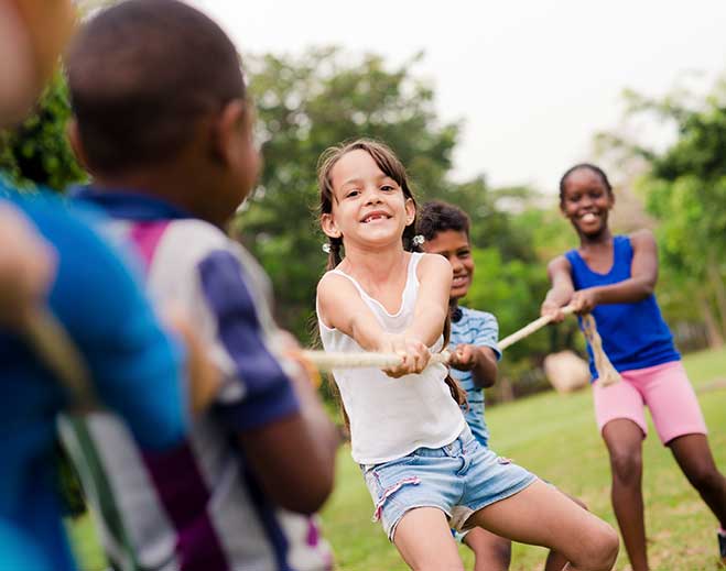 Children playing tug of war outdoors