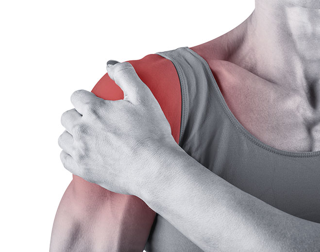 Person holding painful shoulder area