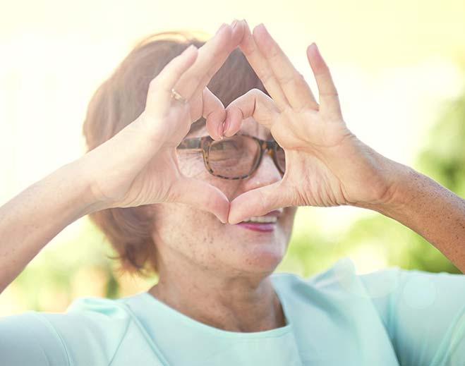 Person forming heart shape with hands