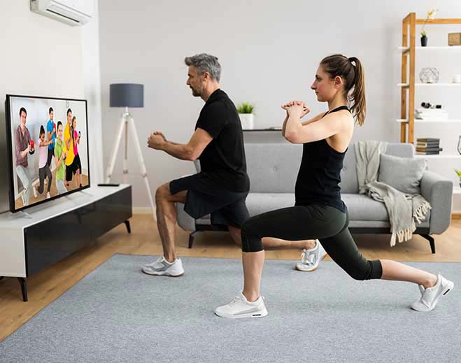 Adults exercising with virtual fitness class